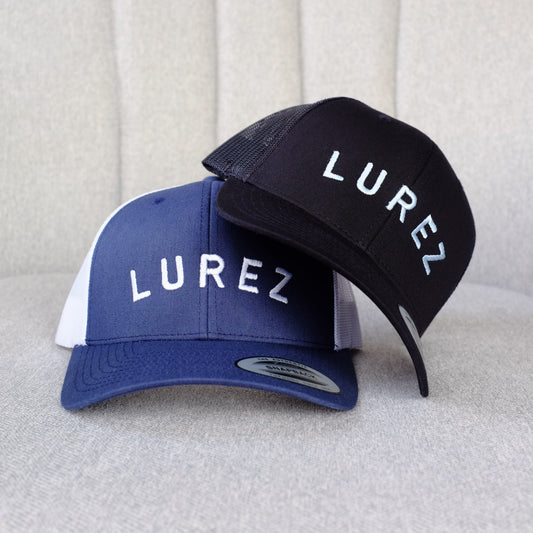 Two caps with 'LUREZ' branding on a light gray background