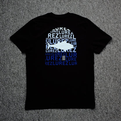 Black t-shirt with white and blue text on a gray surface